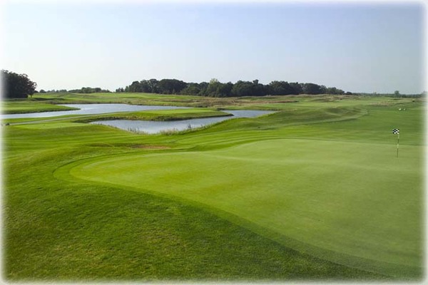 View of a water hazard beyond a hole on the course at Shepherd's Crook